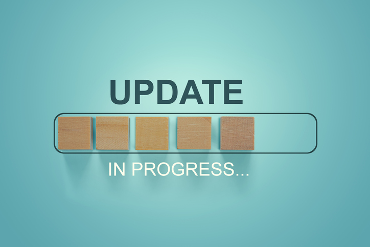 Wooden blocks with the word UPDATE  in loading bar progress.