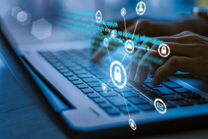 security Business, technology, internet and networking concept. Young businesswoman working on his laptop in the office, select the icon security on the virtual display.