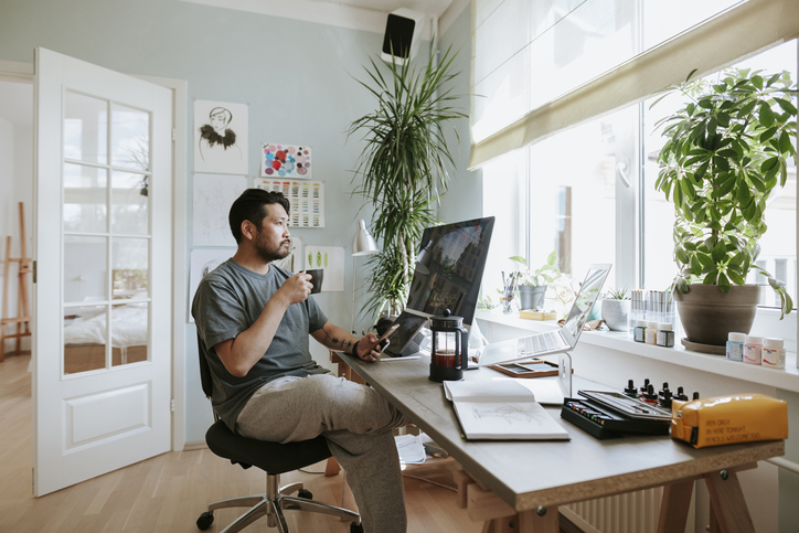 Digital artist contemplates during coffee break in his home office Photo series of Japanese digital artist at his home studio taking a coffee break.